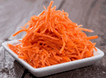 Салат из моркови, с чесноком, орехами и с растительным маслом.
